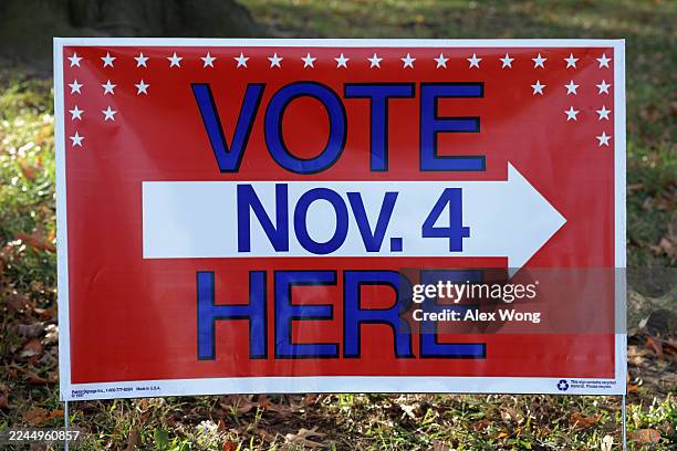 Sign that read "Vote Here" is on disp outside a polling station on November 4, 2025 in Alexandria, Virginia. Virginians hit the poll on Election Day...