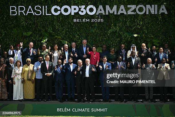 Brazil's President Luiz Inacio Lula da Silva gives the thumbs up alongside heads of state and representatives as they pose for the family photo of...
