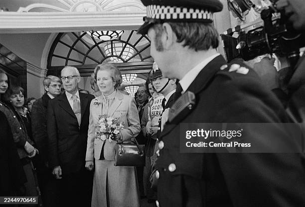 Conservative Party leader Margaret Thatcher leaves Chelsea Town Hall with her husband Denis Thatcher after casting their votes in the General...