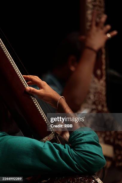 close up of hands playing string musical instrument. - musical instrument string stock pictures, royalty-free photos & images