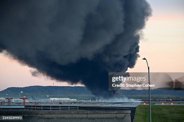 Fire and smoke mark where a UPS cargo plane crashed near Louisville Muhammad Ali International Airport on November 04, 2025 in Louisville, Kentucky....