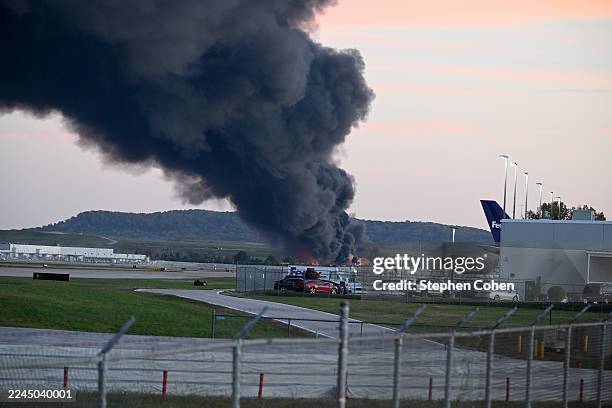Fire and smoke mark where a UPS cargo plane crashed near Louisville Muhammad Ali International Airport on November 04, 2025 in Louisville, Kentucky....
