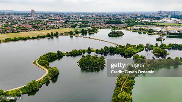 aerial view of walthamstow reservoirs in london with surrounding urban housing and green landscape, historic victorian water supply system and natural habitat, environmental conservation and city planning concept - public utility stock pictures, royalty-free photos & images