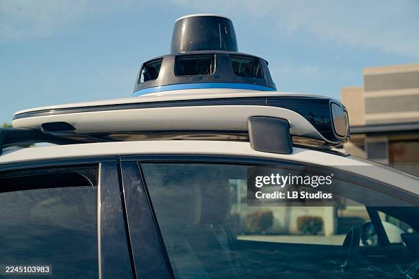 self-driving car with sensor equipment mounted on the roof under a clear blue sky. california, usa - driverless car stock pictures, royalty-free photos & images