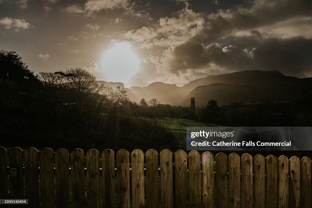 A glorious sunrise view over a round topped fence