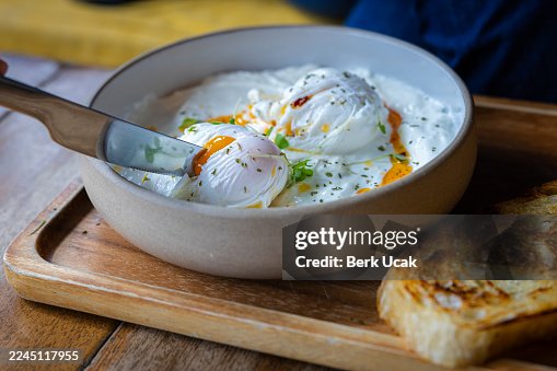 Poached egg serving with garlic yogurt, breakfast plate. Poached egg serving with garlic yogurt, breakfast plate.
