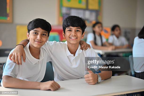 two school friends posing in class - indian subcontinent stock pictures, royalty-free photos & images