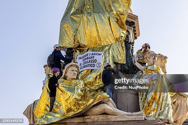 In Turin, Italy, on November 7 Extinction Rebellion covers the statue of Camillo Cavour in Turin's Piazza Carlina with thermal sheets and signs...