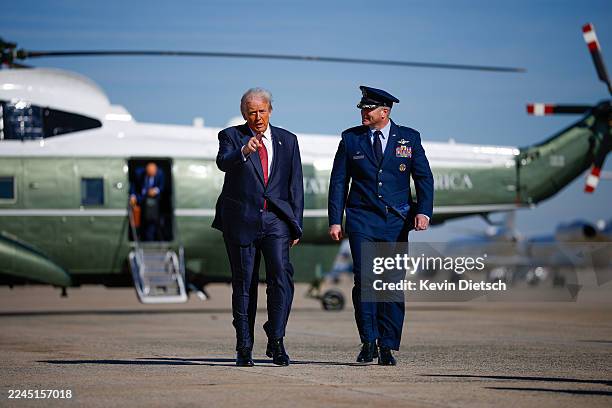 President Donald Trump and U.S. Air Force Col. Christopher M. Robinson walks towards Air Force One on November 05, 2025 at Joint Base Andrews,...