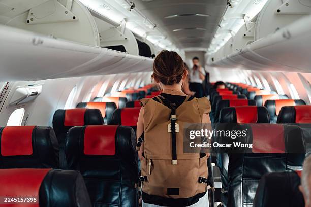 young asian woman boarding an aeroplane - pasajero fotografías e imágenes de stock