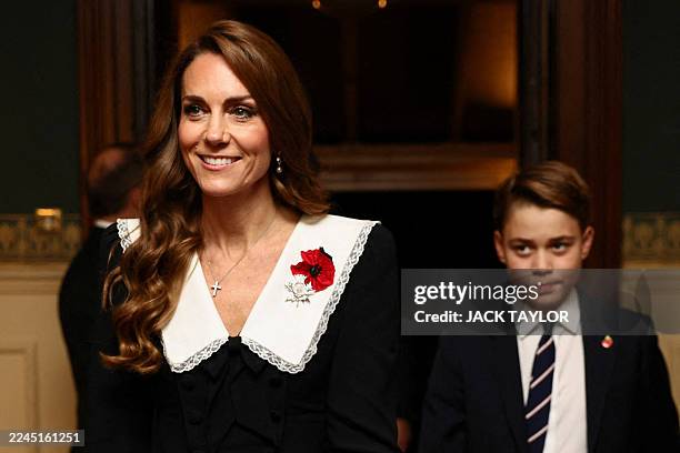 Britain's Catherine, Princess of Wales and Britain's Prince George of Wales arrive to attend The Royal British Legion Festival of Remembrance event...