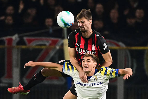 Milan's Italian defender Matteo Gabbia heads the ball as he fights for it with Parma's Argentinian forward Mateo Pellegrino during the Italian Serie...