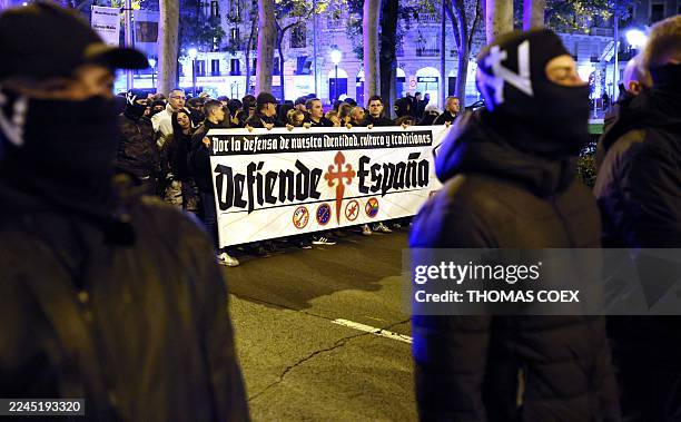 Members of Spanish neonazi group Nucleo Nacional hold banners reading 'Defend Spain' during a demonstration called to protest 'against the corrupt...