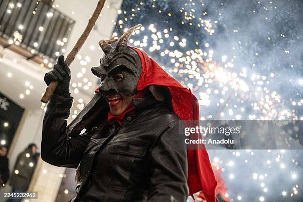 People dressed as devils danced among firecrackers during the traditional "correfoc" festival in eastern Spain on November 8, 2025. More than 200...