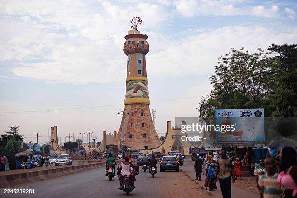 Motorists drive toward the Africa Tower, a monument symbolizing the unity of African nations, in Bamako on November 8, 2025. France on November 7,...