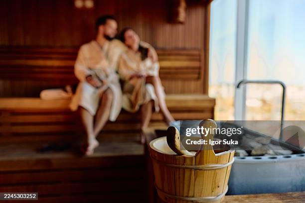 couple relaxing in sauna enjoying wellness and steam - spa bildbanksfoton och bilder