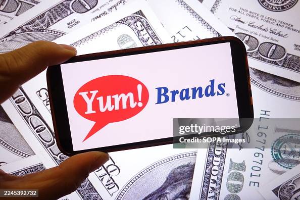 In this photo illustration, the Yum Brands company logo is In this photo illustration, the Yum Brands company logo is