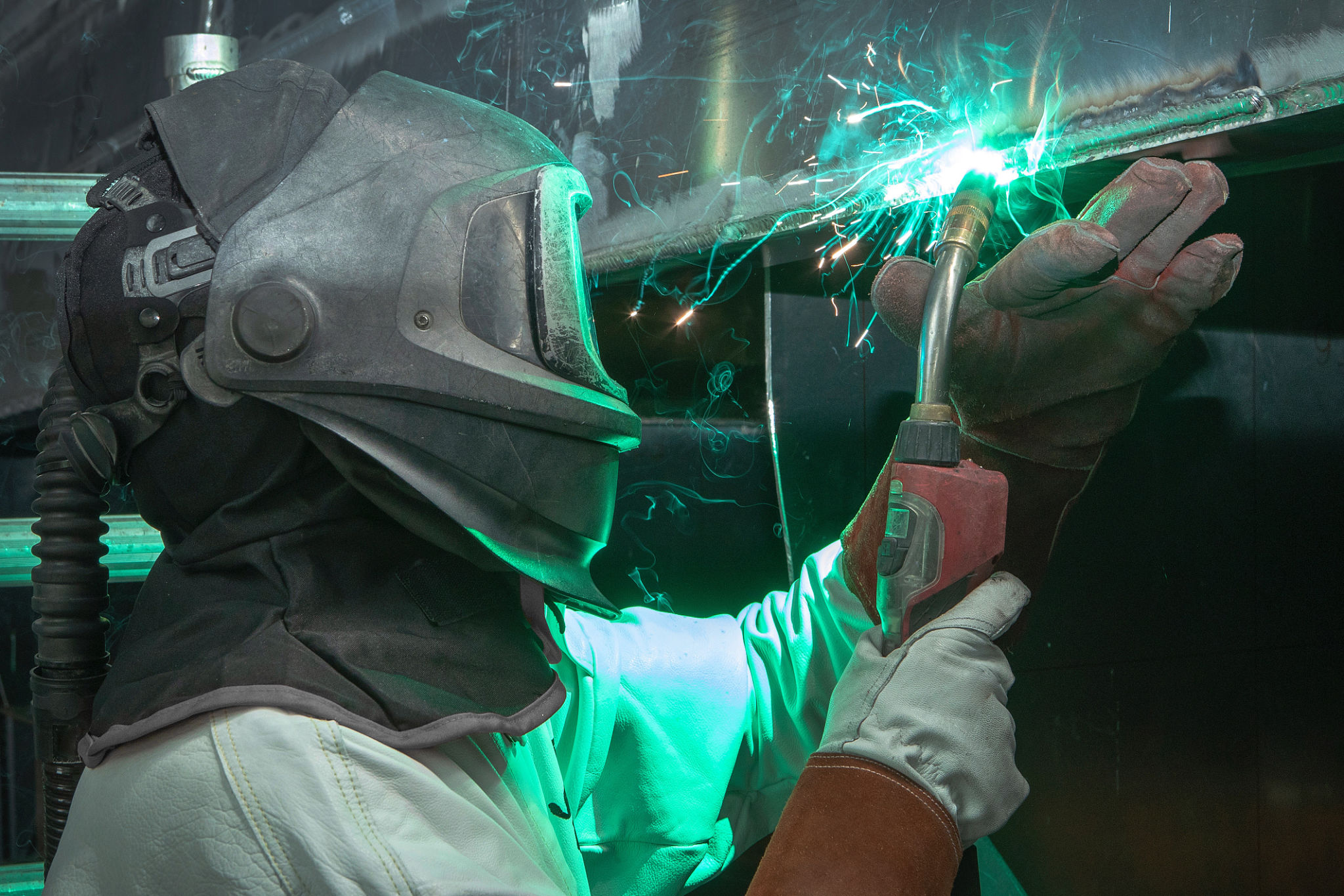 Welder at work at shipyard. Welding aluminium Welder at work at shipyard. Welding aluminium