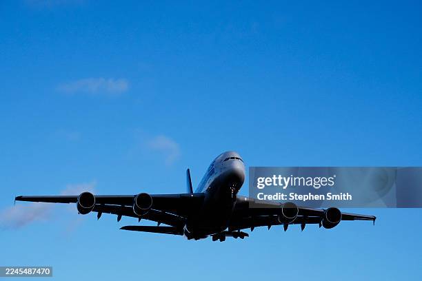 airbus a380 flying overhead on its final landing approach - undercarriage stock pictures, royalty-free photos & images
