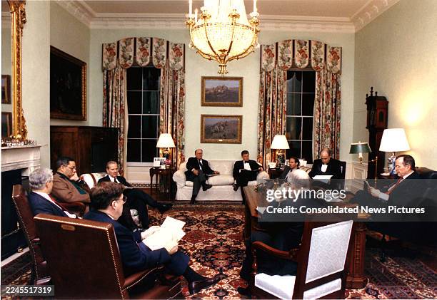 President George HW Bush meets with advisors in the White House residence office, Washington DC, February 21, 1991. Pictured are, clockwise from fore...