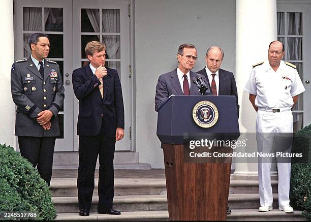 President George HW Bush speaks from a lectern outside the White House, Washington DC, August 10, 1989. Pictured are, from left, US Army General...