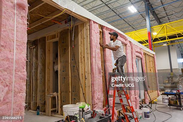 Romulus, Michigan, Workers build apartments in Ginosko Modular 's factory using modular construction methods. The units will be assembled into an...