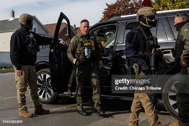 Border Patrol Cmdr. Gregory Bovino walks with other agents while conducting an immigration enforcement action in the Brighton Park neighborhood on...