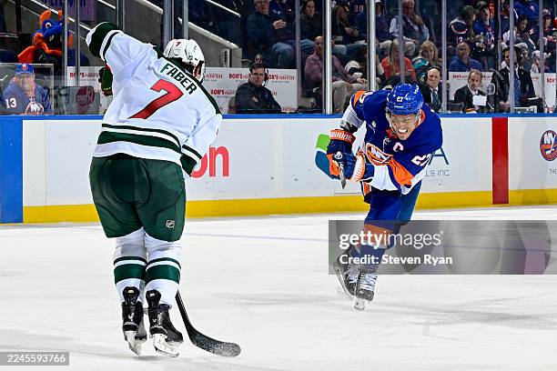 Kyle Palmieri of the New York Islanders attempts a shot against Brock Faber of the Minnesota Wild during a game at UBS Arena on November 07, 2025 in...