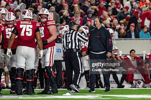 Wisconsin Badgers head coach Luke Fickell talks with a referee during a timeout against the Washington Huskies at Camp Randall Stadium in Madison,...
