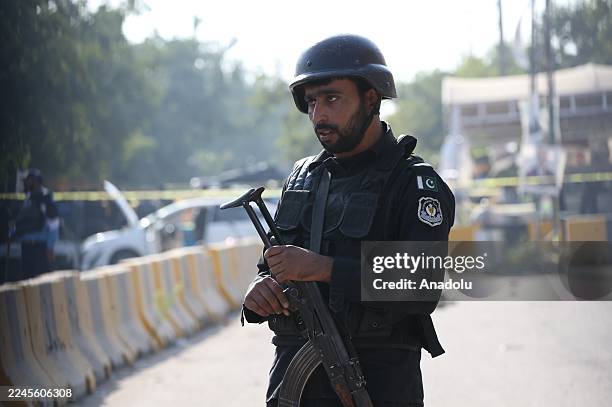 Security forces take measures at the scene where at least 12 people were killed and several others injured in an explosion outside a court complex in...