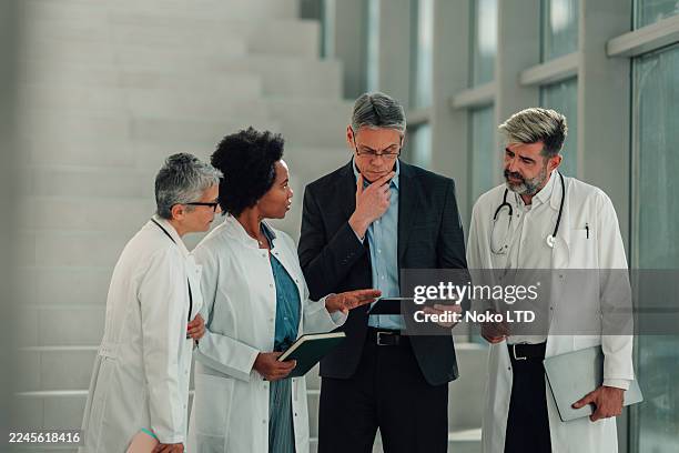 diverse medical team collaborating on new healthcare project - medical director stock pictures, royalty-free photos & images