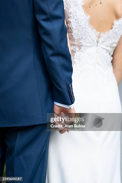 bride and groom holding hands at a wedding - wedding ceremony stock pictures, royalty-free photos & images