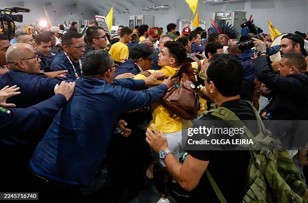 Security personnel clash with indigenous people and students as they storm the venue during the COP30 UN Climate Change Conference in Belem, Para...