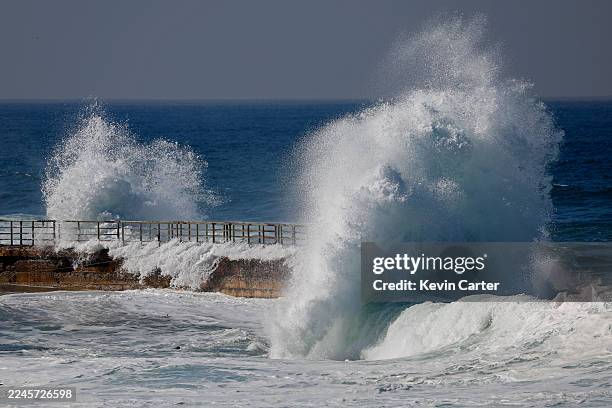Large wave breaks over the sea wall at the La Jolla Children's Pool during a high King Tide on November 7, 2025 in San Diego, CA. A King Tide is a...