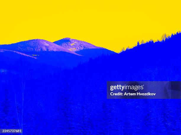 abstract blue forest mountains with yellow sky - unexpected stock pictures, royalty-free photos & images