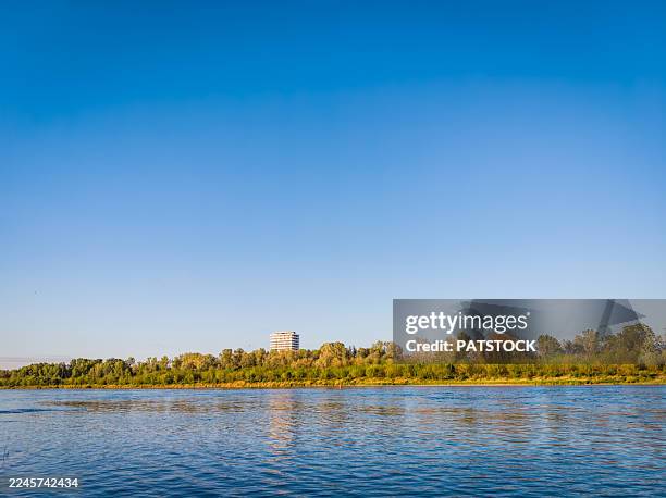 cityscape across the river - riverbank stock pictures, royalty-free photos & images