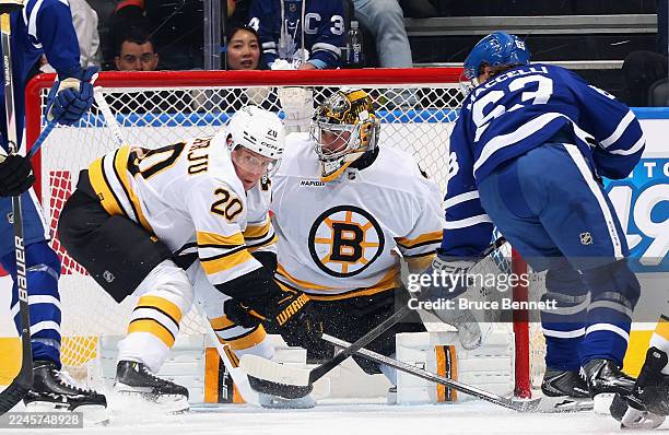 Jeremy Swayman of the Boston Bruins playing in his 200th NHL game defends against Matias MacCelli of the Toronto Maple Leafs at Scotiabank Arena on...