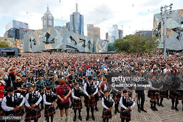 Bagpipers seen performing during a record-breaking attempt at Federation Square in Melbourne Bagpipers gather at Federation Square in Melbourne to...