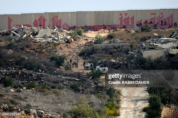 Troops from the United Nations Interim Force in Lebanon patrol near the southern Lebanese border village of Kfar Kila on November 12, 2025. Israel...