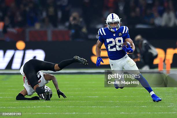 Terrell of Atlanta Falcons falls to the floor as Jonathan Taylor of Indianapolis Colts runs with the ball before scoring a touchdown uring the NFL...