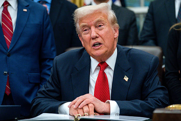President Donald Trump speaks prior to signing funding legislation to reopen the US government, in the Oval Office of the White House in Washington,...