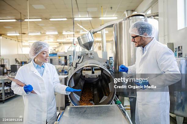 food factory workers checking product quality on production line - hair net stock pictures, royalty-free photos & images