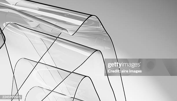 transparent wavy plastic sheets flowing in the air - pvc fotografías e imágenes de stock