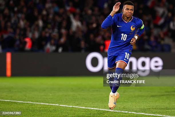 France's forward Kylian Mbappe celebrates after shooting a penalty kick to score his team first goal during the 2026 World Cup qualifiers Europe zone...