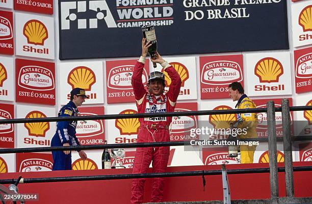 Race winner Ayrton Senna celebrates with Moët et Chandon champagne in front of second placed Damon Hill and third placed Michael Schumacher, on the...