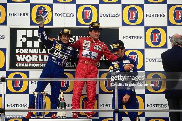 Race winner Ayrton Senna invites second placed Alain Prost and third placed Damon Hill on to the top step of the podium, during the Australian Grand...
