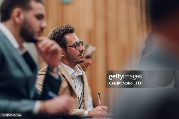 business professional listening in a conference or lecture - dressing up stock pictures, royalty-free photos & images