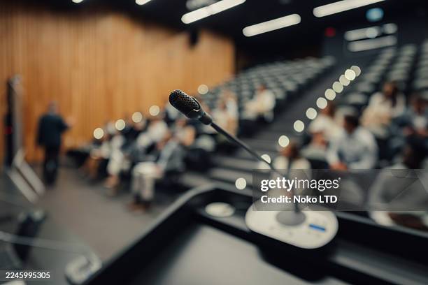 microphone on lectern during conference presentation - auditorium stock pictures, royalty-free photos & images