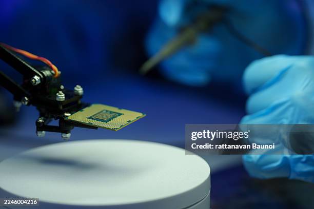 the research lab produces semiconductor cpus using a microscope. - quantum stock pictures, royalty-free photos & images