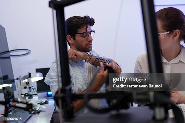 engineers work with a 3d printer to print a clear white plastic model. state-of-the-art technology, selective focus, in a lab. - prototype stock pictures, royalty-free photos & images